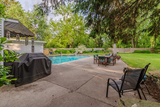 view of swimming pool with a patio, a yard, and a grill