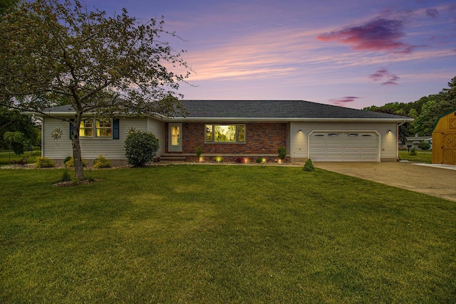 ranch-style house with a garage and a yard