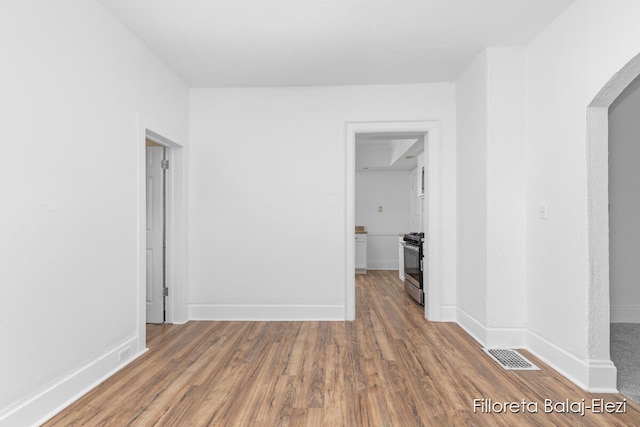 empty room with hardwood / wood-style floors