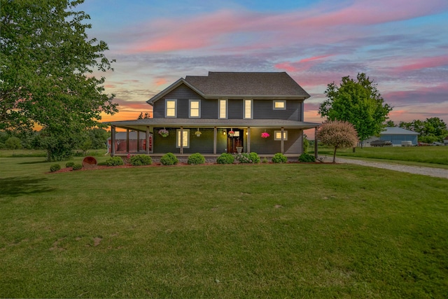 farmhouse-style home featuring a porch, driveway, and a front lawn