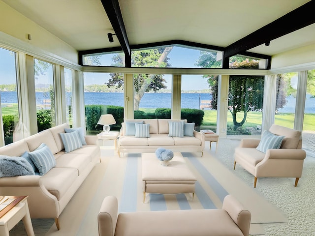 sunroom / solarium with a water view, a healthy amount of sunlight, and vaulted ceiling