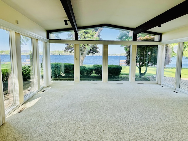 unfurnished sunroom featuring a water view and a wealth of natural light