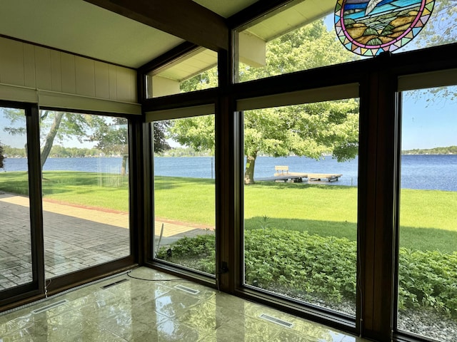 doorway featuring vaulted ceiling with beams, floor to ceiling windows, and a water view