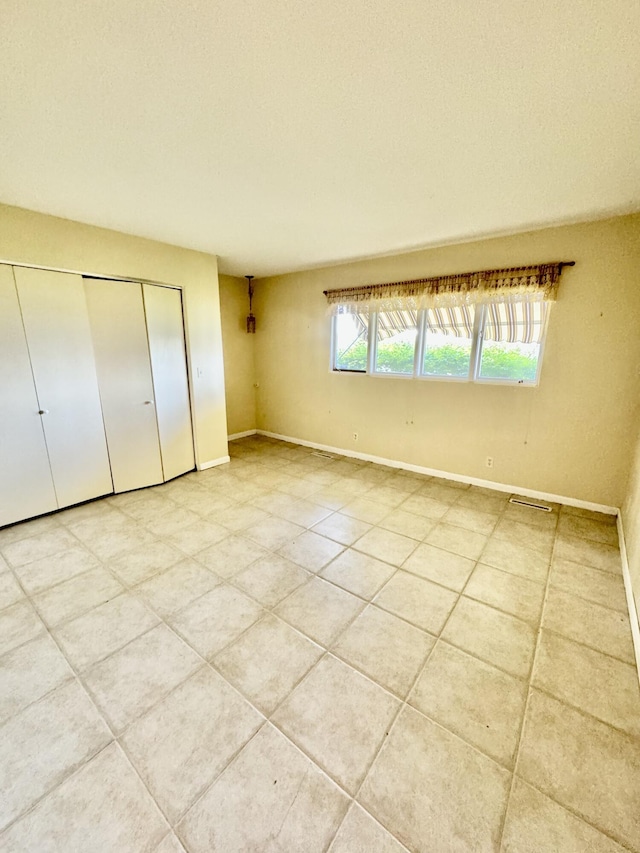 unfurnished bedroom with light tile patterned floors