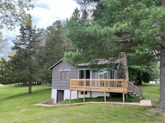 back of house featuring a yard and a wooden deck