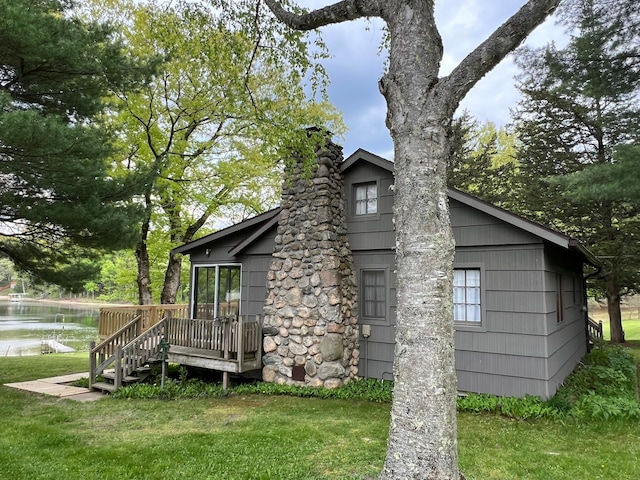 view of side of property with a yard