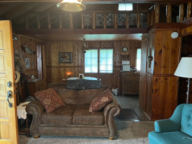 carpeted living room with wooden walls