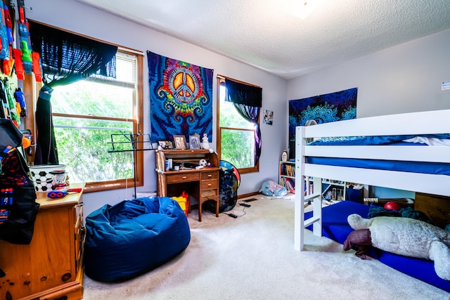 carpeted bedroom featuring a textured ceiling