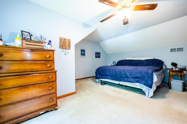 carpeted bedroom with ceiling fan and vaulted ceiling