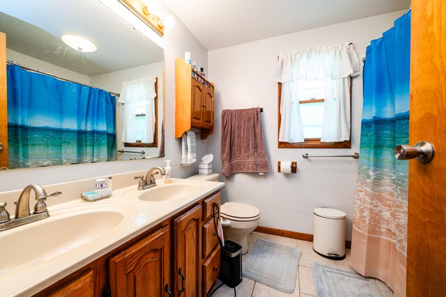 bathroom featuring toilet, vanity, and tile patterned floors