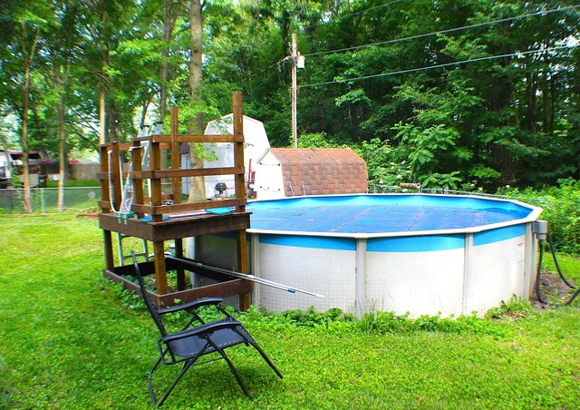 view of pool featuring a yard