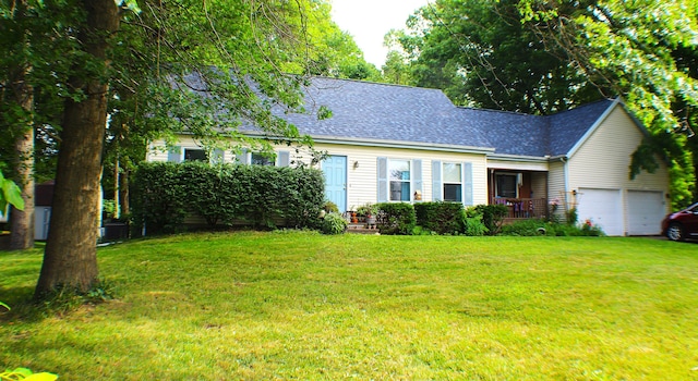 cape cod home featuring a garage and a front yard