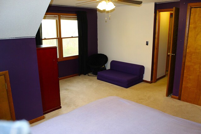 bedroom featuring light carpet and ceiling fan