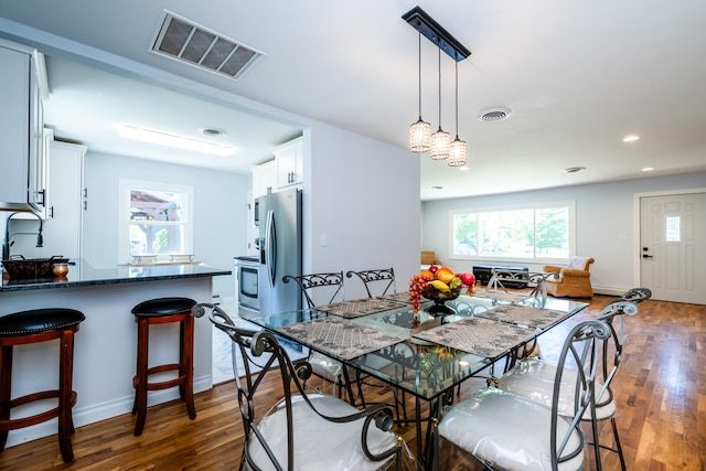 dining area with dark hardwood / wood-style floors