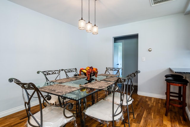 dining space featuring dark wood-type flooring