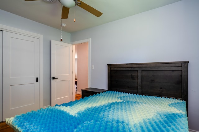 bedroom with ceiling fan and hardwood / wood-style floors