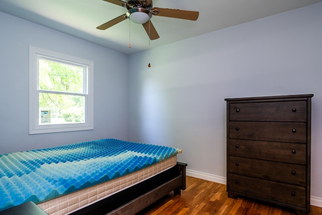 bedroom featuring dark hardwood / wood-style flooring and ceiling fan