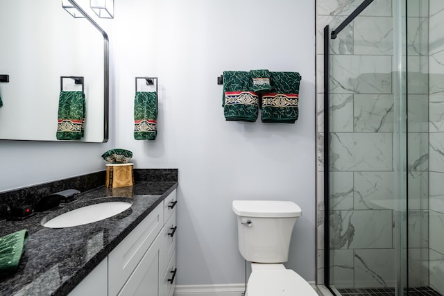 bathroom with a shower with shower door, vanity, and toilet