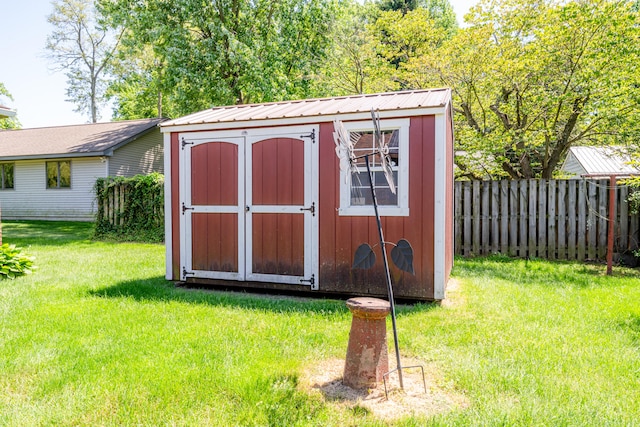 view of shed / structure with a lawn