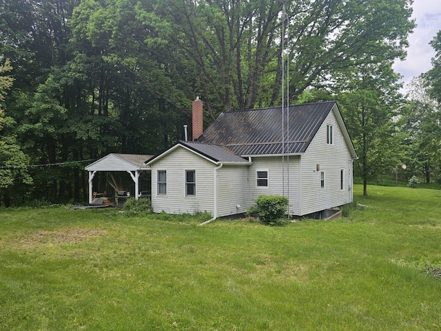 rear view of property with a lawn and a gazebo