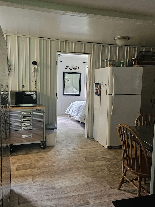 kitchen with white refrigerator and hardwood / wood-style flooring