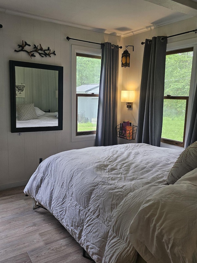 bedroom featuring hardwood / wood-style flooring and ornamental molding