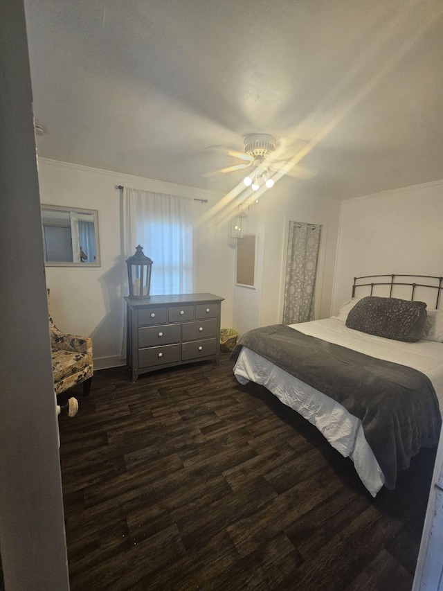 bedroom with dark hardwood / wood-style flooring and ceiling fan