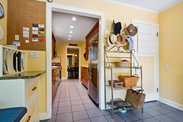 kitchen with stainless steel refrigerator and tile patterned flooring