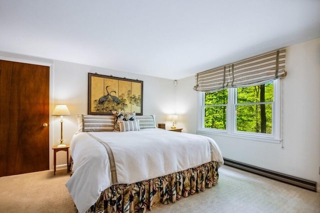 carpeted bedroom with a baseboard radiator