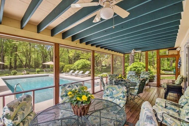 sunroom with beam ceiling and ceiling fan