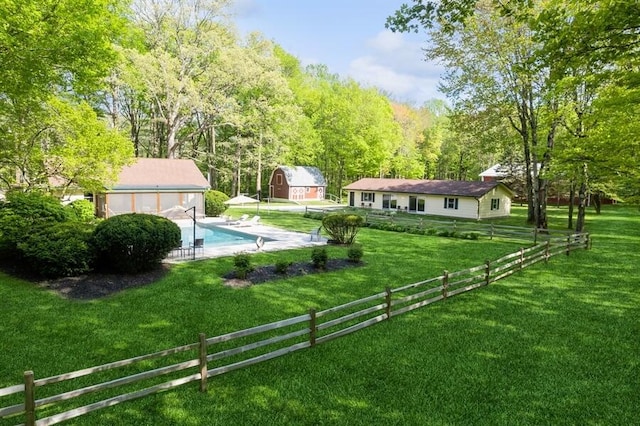 view of yard with an outbuilding and a fenced in pool