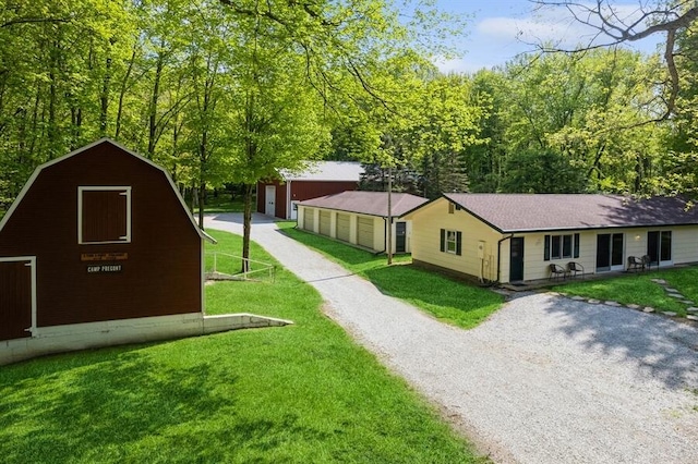 view of front of house with an outdoor structure and a front yard