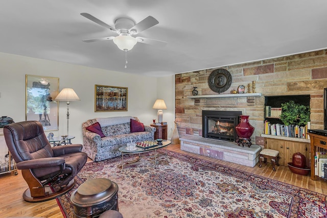 living room with hardwood / wood-style floors, a fireplace, and ceiling fan