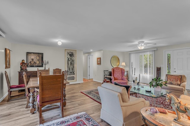 living room featuring ceiling fan and light hardwood / wood-style flooring