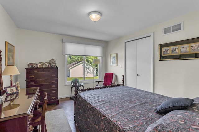 bedroom featuring dark hardwood / wood-style flooring and a closet