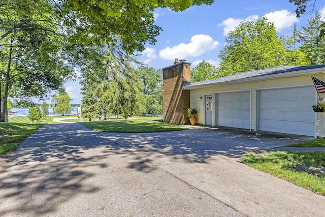 view of side of home with a yard