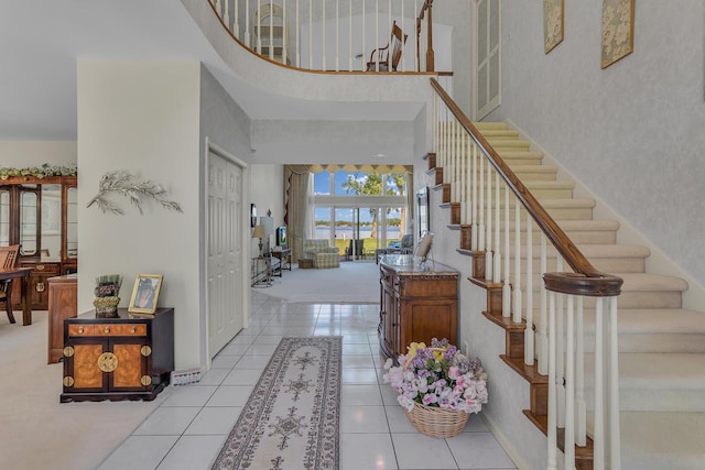 tiled foyer with a towering ceiling