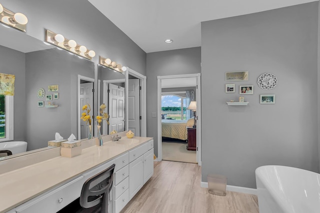 bathroom featuring vanity, a bathtub, and hardwood / wood-style flooring