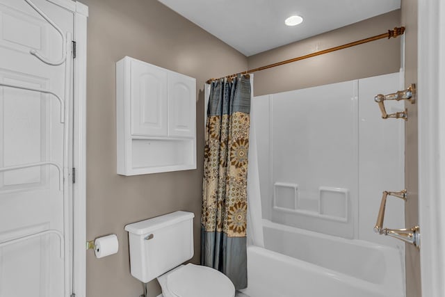 bathroom with toilet and shower / bath combo with shower curtain