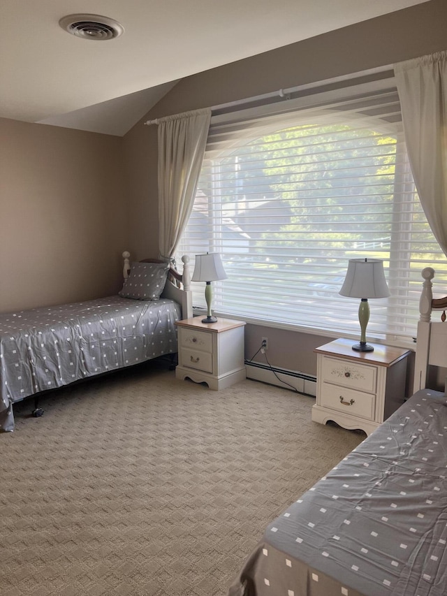 bedroom with vaulted ceiling, light carpet, and baseboard heating