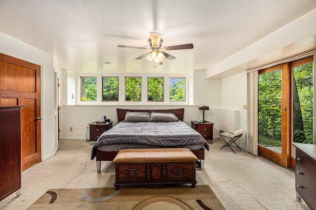 bedroom with ceiling fan, light colored carpet, and access to outside