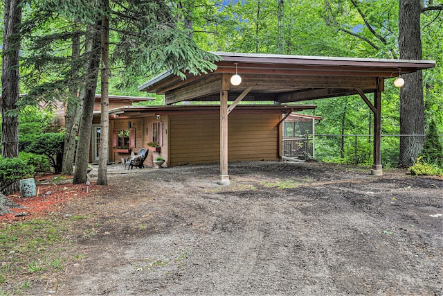 view of vehicle parking with a carport