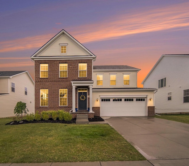 view of front of home with a garage and a yard