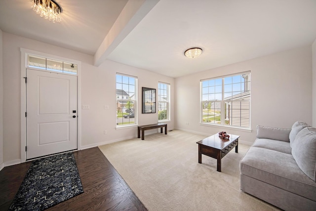 interior space with a chandelier, beam ceiling, and hardwood / wood-style flooring