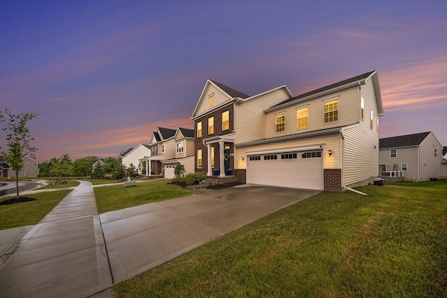 view of front of house featuring a yard and a garage