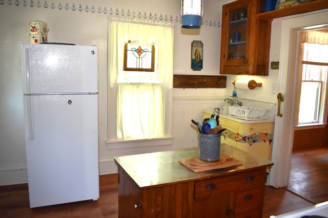 kitchen featuring white fridge and dark wood-type flooring