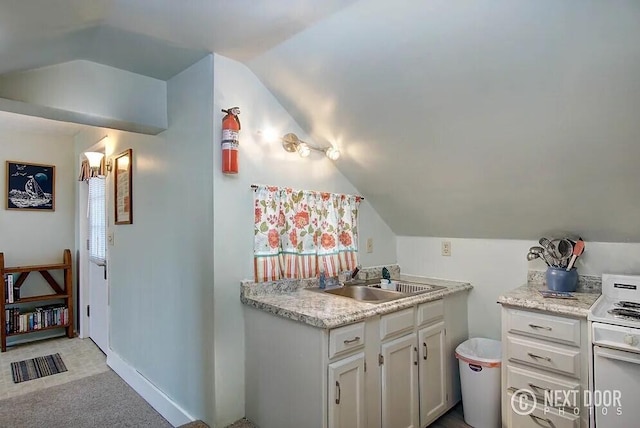 kitchen with white stove, light colored carpet, sink, and vaulted ceiling