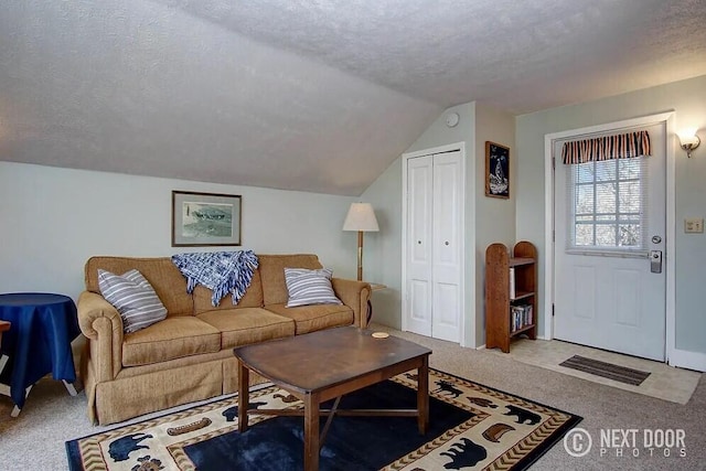 carpeted living room featuring a textured ceiling and vaulted ceiling