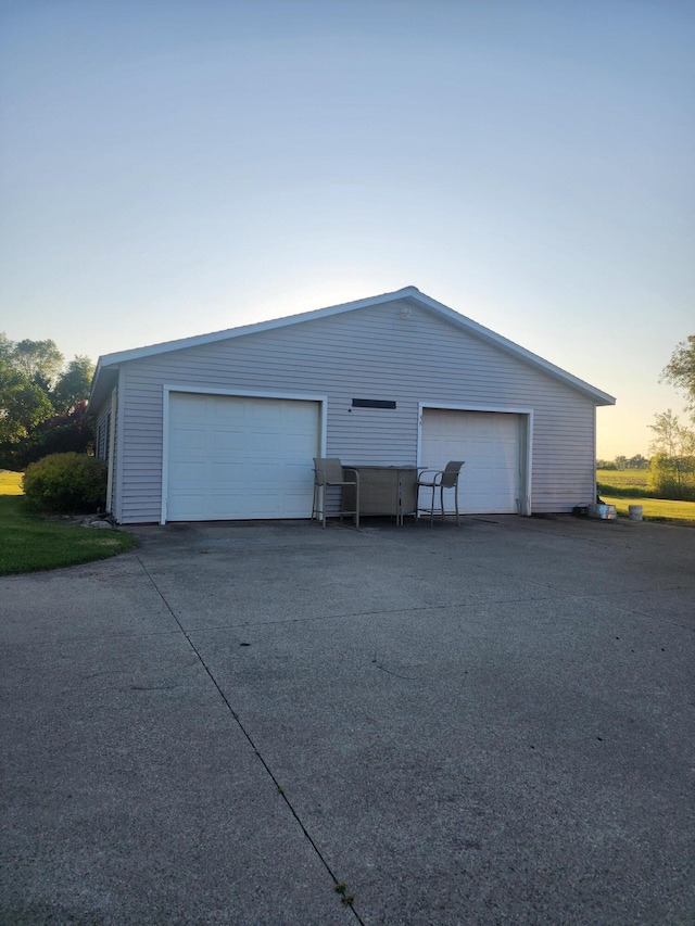 view of garage at dusk