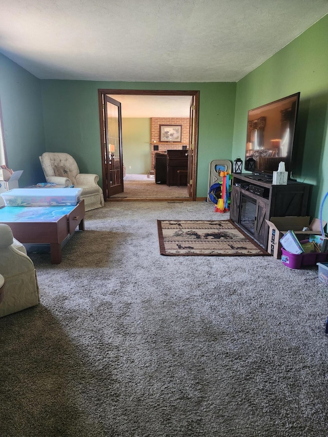 carpeted living room featuring a textured ceiling